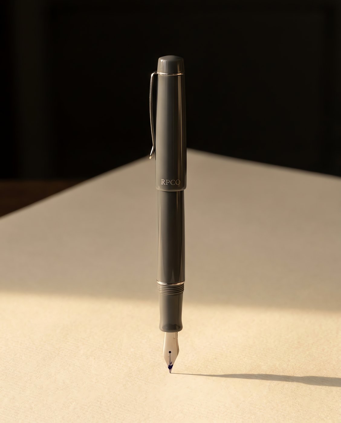 Entry Standard — A graphite grey cast acrylic fountain pen with a plain steel medium nib and a simple spring steel clip.