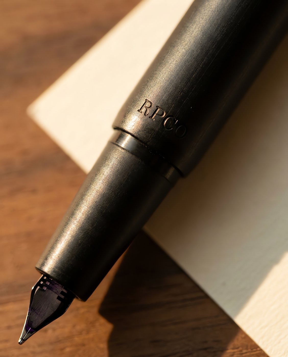 Margin Slim, Ebonite — A slim matte black hard rubber fountain pen with a low satin sheen and a small fine nib in close detail.