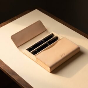 Pen Case, Two Pen — A hard-sided two pen case in pale undyed leather lying open to show two fountain pens separated by a felt-lined divider.