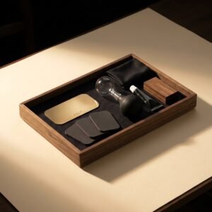 Bench Service Kit — A shallow walnut tray with a felt base holding a brass shim, three sheets of micro-mesh, a bulb syringe, a small tube of grease, a cloth and a hardwood nib block.